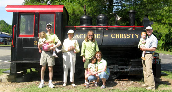 Four generations of Christy's standing in front of an engine that was owned by my Great Great Grandfather for his brick making business.